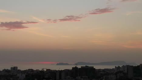 Soft-pink-timelapse-cityscape-from-Miraflores-looking-to-San-Lorenzo-island,-sunset