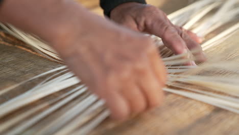 Traditional-Asian-Bamboo-Weaving-by-Hand,-Interlacing-Strips-of-Bamboo-creating-a-Bamboo-Mat