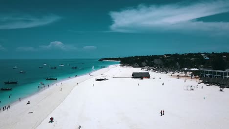 Smooth-aerial-flight-fly-from-up-to-down-crane-drone-shot-at-paradise-white-sand-dream-beach-blue-water-on-zanzibar,-africa-tanzania-2019