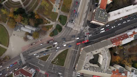 Wide-Aerial-ascending-top-shot-of-cars-traffic-driving-Racianske-myto-intersection-in-Bratislava,-Slovakia