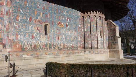 Wall-Detail-At-Voronet-Monastery,-Moldavia,-Romania---wide,-static-shot