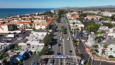 Aerial-backward-movement-shot-over-pacific-coast-highway-with-the-well-planned-town-of-Carlsbad-in-California,-USA-with-the-view-of-the-ocean-in-the-background