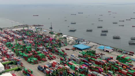 Forward-aerial-of-stacked-containers-at-Tanjung-Priok-port,-Indonesia