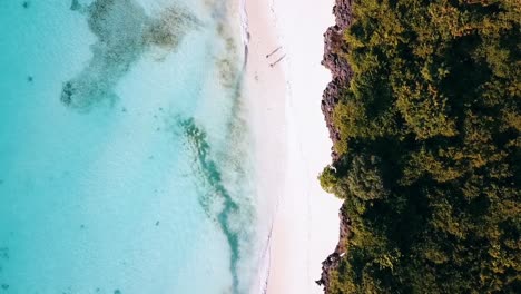 Fantastic-aerial-flight-bird's-eye-view-top-drone-camera-pointing-down-drone-shot-turquoise-water-white-sand-beach