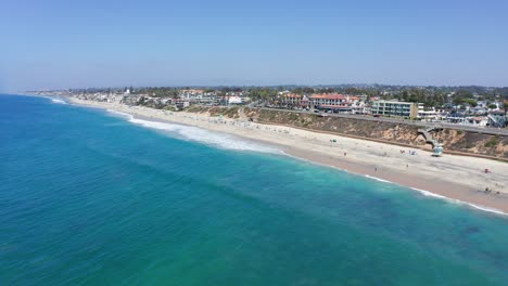 Drone-shot-flying-over-the-sea-towards-Carlsbad-State-Beach-in-California,-USA