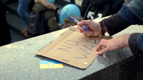 Preparing-a-protest-sign-for-a-demonstration-against-war-in-Ukraine