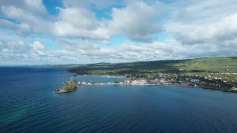 Drone-aerial-view-of-a-shoreline-with-fast-moving-clouds