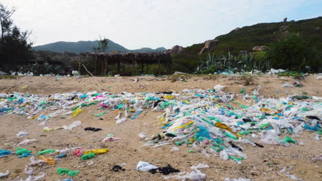 Trucking-shot-of-polluted-Beach-with-Plastic,Waste-and-Trash-in-Asia