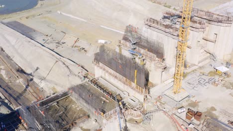 Men-at-Work-on-Concrete-and-Steel-Construction-of-Dominican-Republic-Dam-Structural-Project-on-a-Hot-Sunny-Day,-Aerial-View