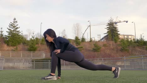 Athletic-woman-performs-lunge-hamstring-stretching-legs