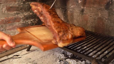 Person-taking-meat-off-the-grill-at-an-Argentinian-asado