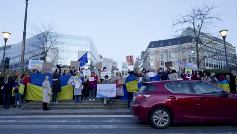 People-with-placards,-banners-and-flags-protest-at-the-Shuman-roundabout-in-the-heart-of-the-European-Union-quarter-in-Brussels