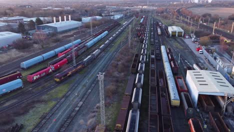 Aerial-view-over-long-train-yard-tracks-and-freight-shipping-tanker-railway-lines-reverse-orbit-right-shot