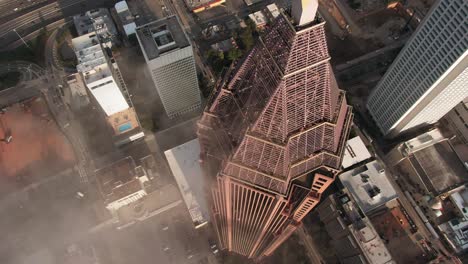 Cinematic-shot-of-a-skyscraper-building-from-an-aerial-view-in-slow-motion,-urban-downtown-background