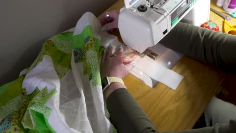 Using-a-sewing-machine-to-attach-the-border-around-the-edge-of-the-joined-quilt-blocks