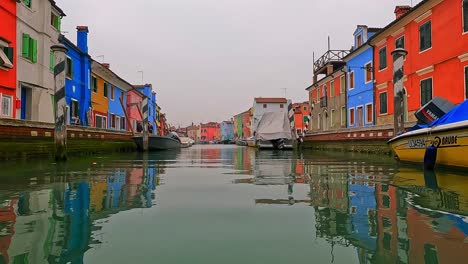 Unusual-and-different-low-angle-panoramic-view-of-Burano-colorful-houses-seen-from-canal-center,-Italy