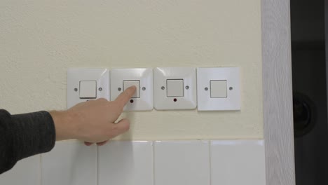 male-hand-pressing-light-switches-turning-lights-off,-scene-gets-dark,-indoor