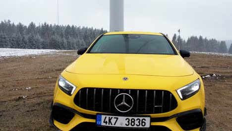 Slow-motion-video-Yellow-Mercedes-Benz-car-driving---smooth-aerial-shot