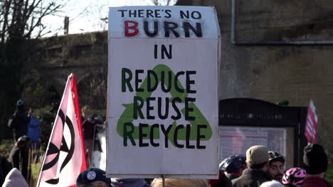 A-placard-is-held-up-that-reads,-“There’s-no-burn-in-reduce-reuse-recycle”-at-a-protest-opposing-a-new-waste-incinerator-at-Edmonton