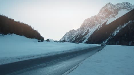 Vintage-camper-van-driving-on-outdoor-national-park-winter-landscape-road