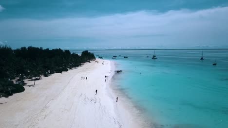 Fantastic-aerial-flight-slowly-rise-up-drone-shot-at-white-sand-paradise-dream-beach-over-coast-line-turquoise-water-Zanzibar,-Africa-Tanzania-2019