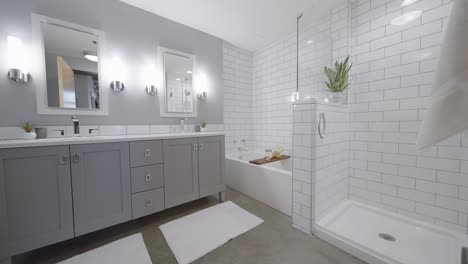 Modern-Bright-and-White-Bathroom-with-Two-Sinks,-a-Shower-and-a-Bath-Tub-in-a-Condo-Building