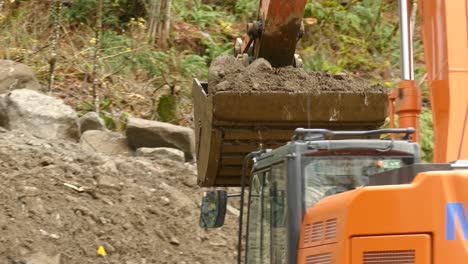 Backhoe-loaders-working-on-landslide-site-near-highway