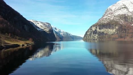 Beautiful-winter-morning-in-Aurlandsfjord-Norway--Aerial-close-to-sea-surface-outside-undredal-between-Flam-and-Gudvangen