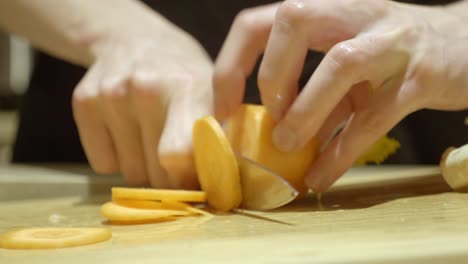 Cutting-Carrot-With-Knife-On-Round-Pieces