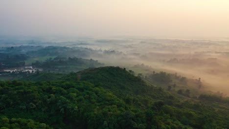 Aerial-foggy-and-misty-hilly-landscape,-drone-scenic-view-of-a-nature-park-with-a-white-mantle-and-copy-space