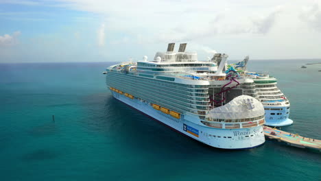 Wide-rotating-drone-shot-of-the-Wonder-Of-The-Seas-the-Royal-Caribbean-cruise-ship-at-dock-in-Cozumel