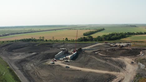 Aerial,-rural-construction-site-in-farmland-countryside