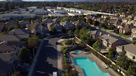 Drone-reveal-shot-over-residential-neighborhood-with-pool-in-the-suburbs