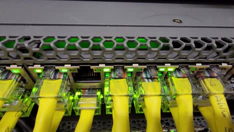 Network-switch-with-yellow-ethernet-cables-and-flashing-lights-indicating-activity