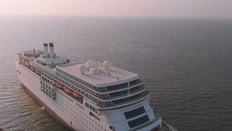 Aerial-View-Of-White-Cruise-Liner-Beached-With-Arabia-Sea-In-Background