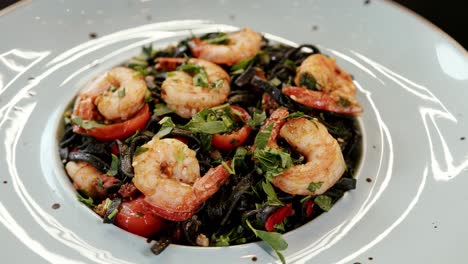 Freshly-served-shrimp-and-tomato-salad-on-white-plate,-close-up
