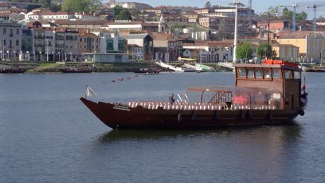 Touristic-boat-Rebelo-on-Douro-River-against-Gaia-Ribeira-on-sunny-day