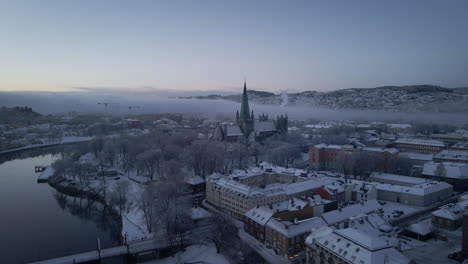 Flying-Towards-The-Nidaros-Cathedral-With-Winter-Landscape-In-Trondheim-City,-Trondelag,-Norway
