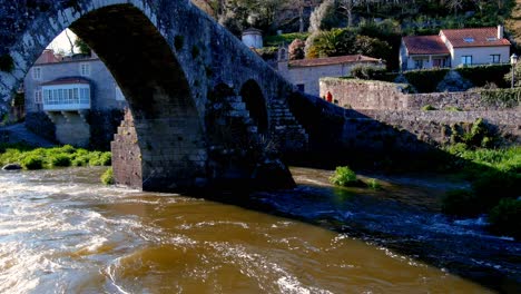 Aerial-View-Of-Stone-Arches-Of-Bridge-of-Ponte-Maceira-Over-The-River-Tambre