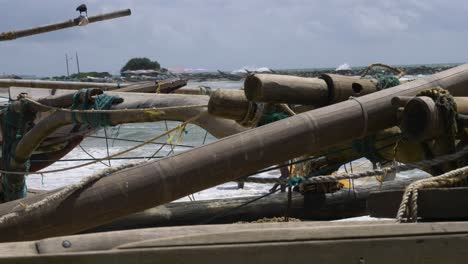 Traditional-wooden-handmade-oruwa,-katamaran-or-fishing-boat-at-the-beach-in-Negombo,-Sri-Lanka
