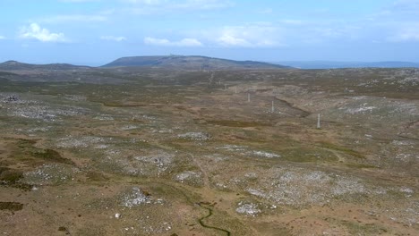 Aerial-Flying-Over-Large-Sierra-Plain-In-Galicia-With-Row-Of-Wind-Turbines-In-Landscape