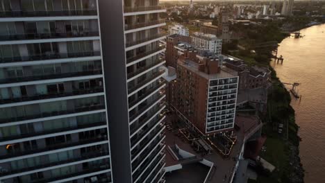 Aerial-drone-shot-of-residential-buildings-in-Puerto-Norte-Atardecer,-Argentina-along-the-banks-of-river-parana-in-the-evening-time-during-sunset