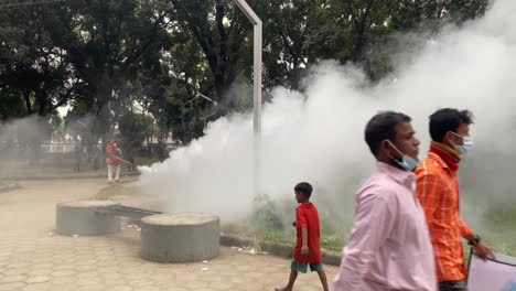 White-Smoke-From-Fogger-Rising-With-People-And-Children-Nearby-In-Dhaka