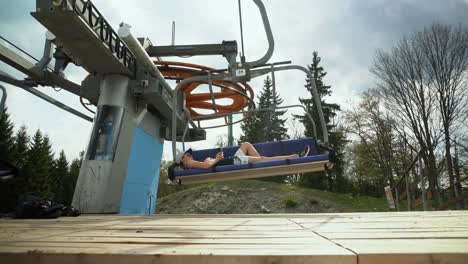 Lone-Guy-Leisurely-Resting-On-A-Ski-Lift-During-Summertime