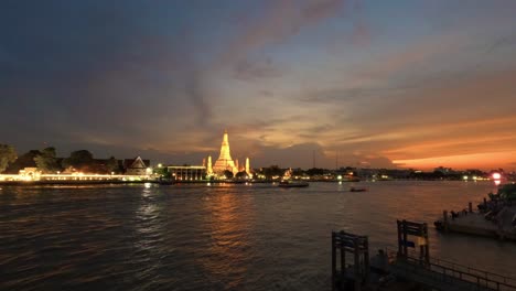 Wat-Arun-and-cruise-ships-in-twilight-time,-Bangkok-city,-Thailand