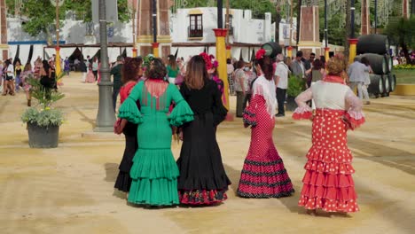 Group-of-women-in-traditional-flamenco-dresses-at-Jerez-Fair,-Spain