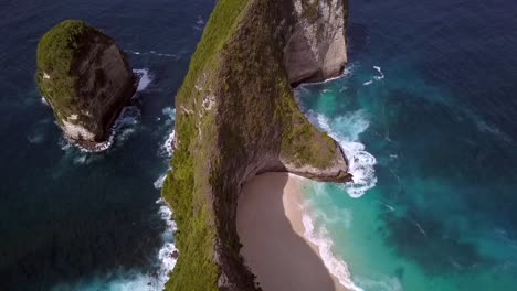 Marvelous-aerial-view-flight-high-bird's-eye-view-drone-shot-instagram-spot-Kelingking-Beach-at-Nusa-Penida-in-Bali-Indonesia-is-like-Jurassic-Park-Cinematic-nature-cliff-view-above-by-Philipp-Marnitz