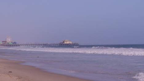 Tilting-down-shot-of-Santa-Monica-pier-on-a-bright-and-sunny-day