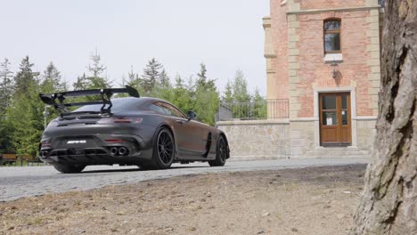 Black-Sports-Car-Driving-into-a-Mansion---Panning-Shot