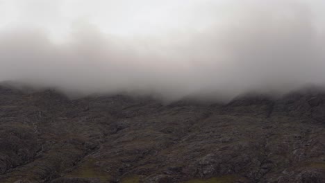 Looking-up-at-Misty-Mountains-covered-in-Low-Cloud